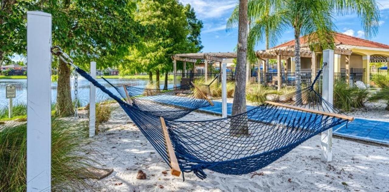 Navy hammocks on the sand beside the lake at Terra Verde